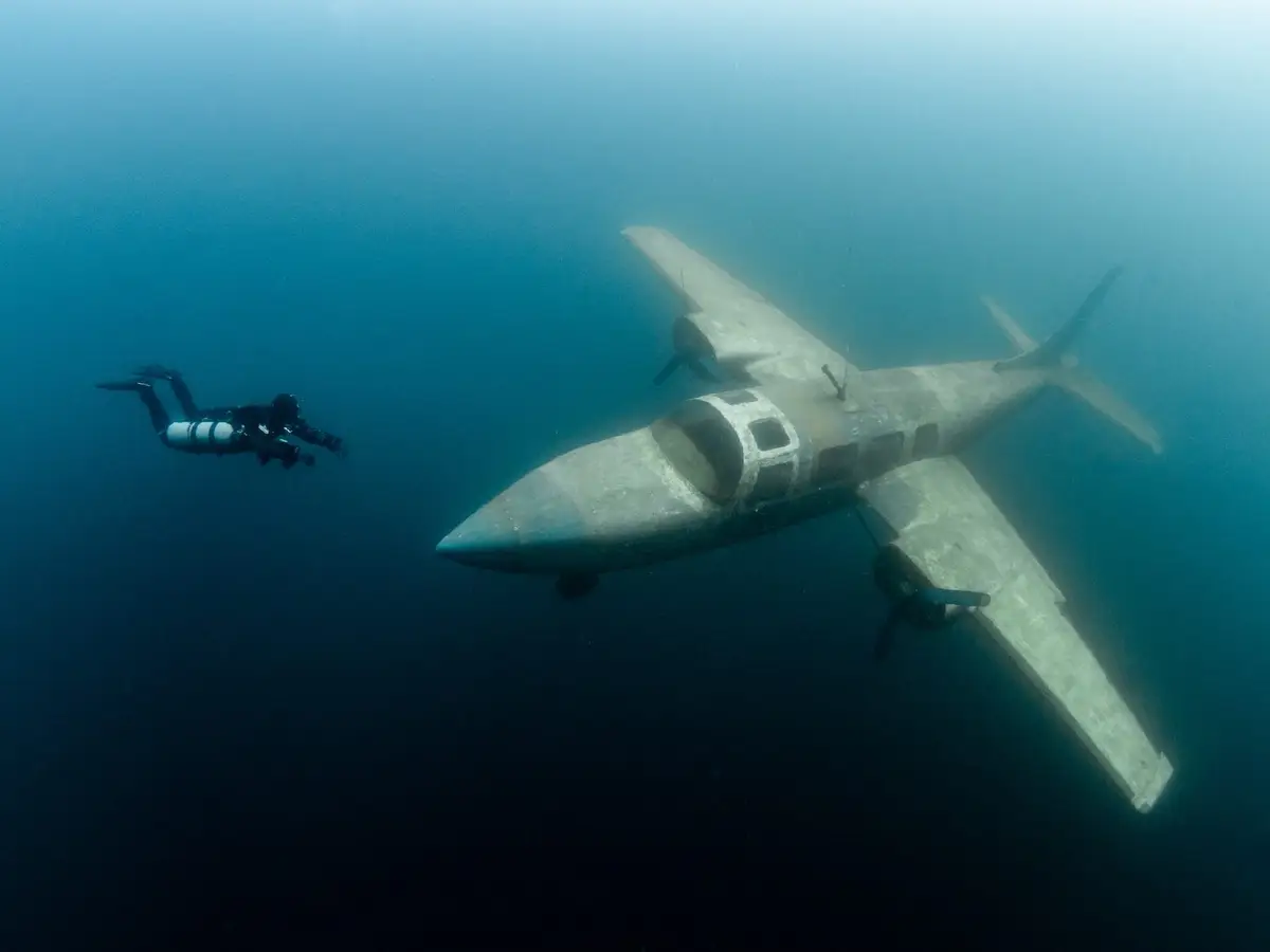 Divers Spot Plane On Ocean Floor